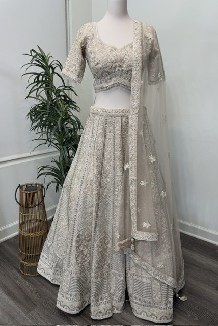 Blush tissue bridal lehenga with pearl-embroidered blouse and net dupatta, full view