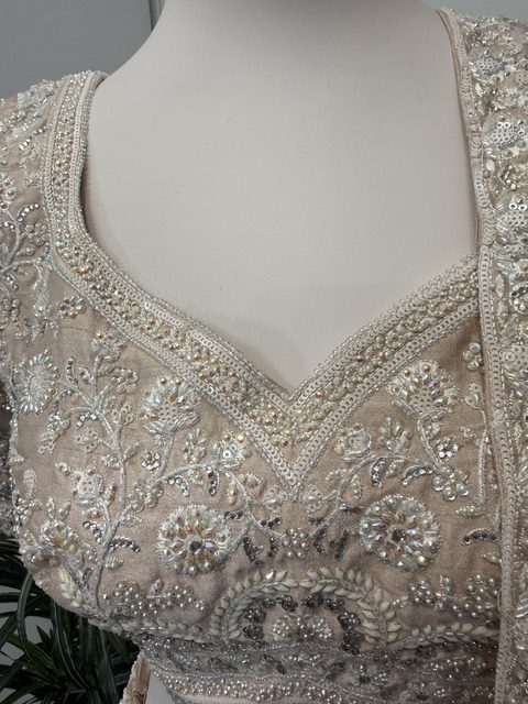 Blush tissue bridal lehenga, pearl-outlined V neckline on the blouse
