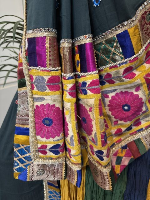 Close view of the green dupatta with embroidered floral patches and multicolour border