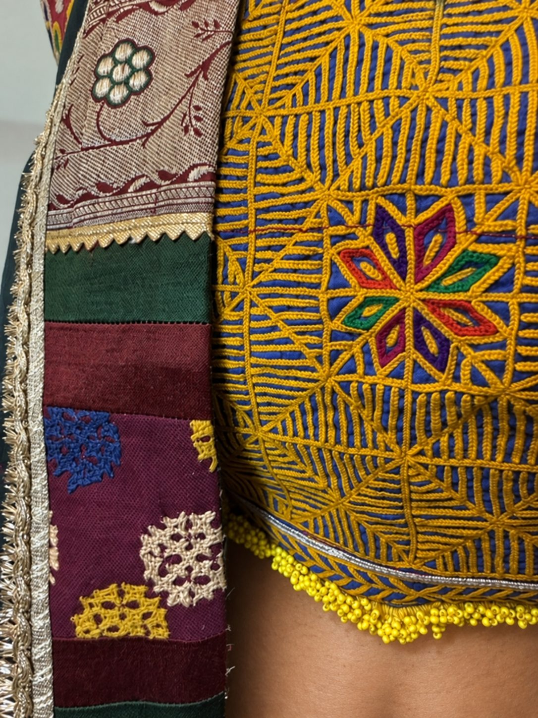 Close view of yellow embroidery on the blouse and the green dupatta border