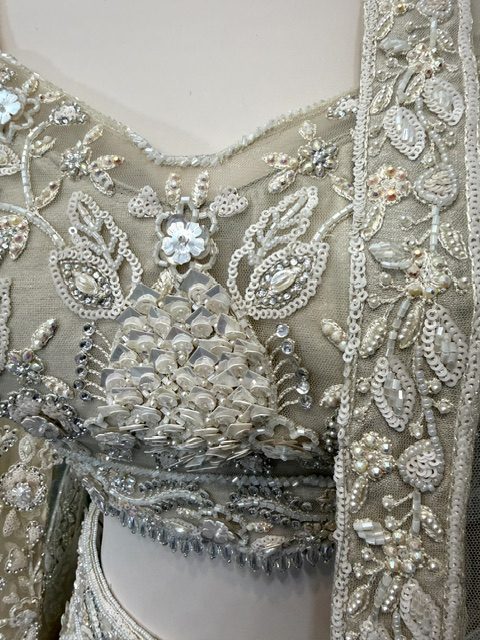 Ivory net bridal lehenga, beaded and sequinned blouse detail