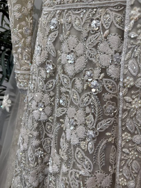 Ivory net bridal lehenga, thread work, sequin and pearl embroidery on the skirt