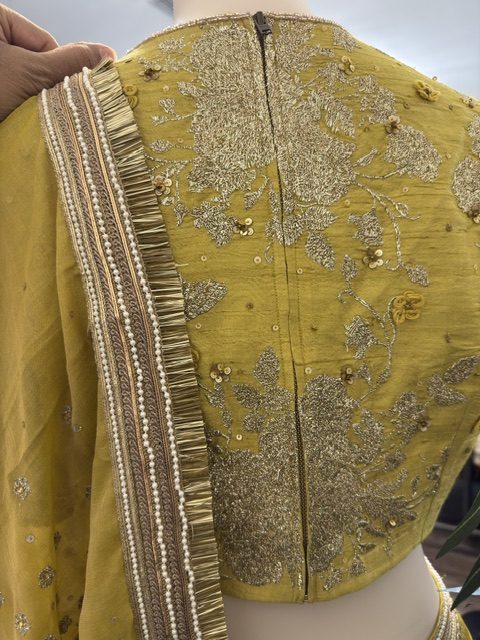 Mustard crushed lehenga with embroidered blouse, blouse back embroidery and dupatta fringe detail