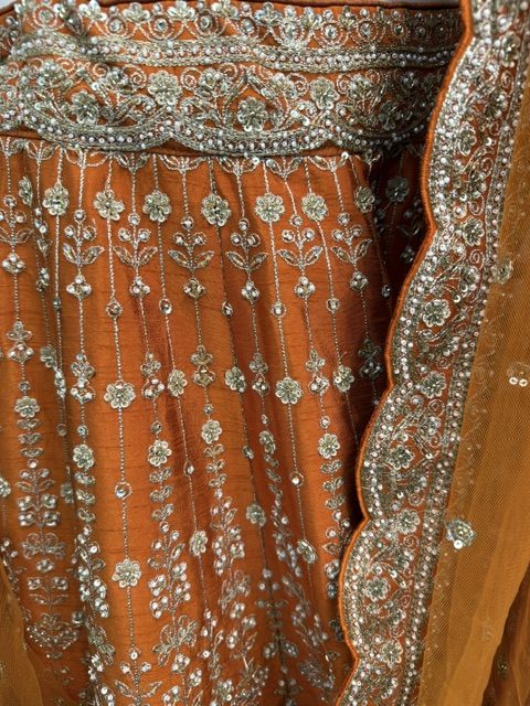 Orange raw silk bridal lehenga, embroidered waistband and scalloped silver dupatta border