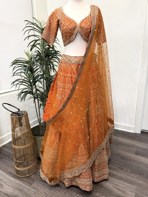 Orange raw silk bridal lehenga with embroidered blouse and net dupatta, full view