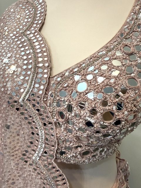 Pink tissue bridal lehenga, close view of the openwork mirror yoke