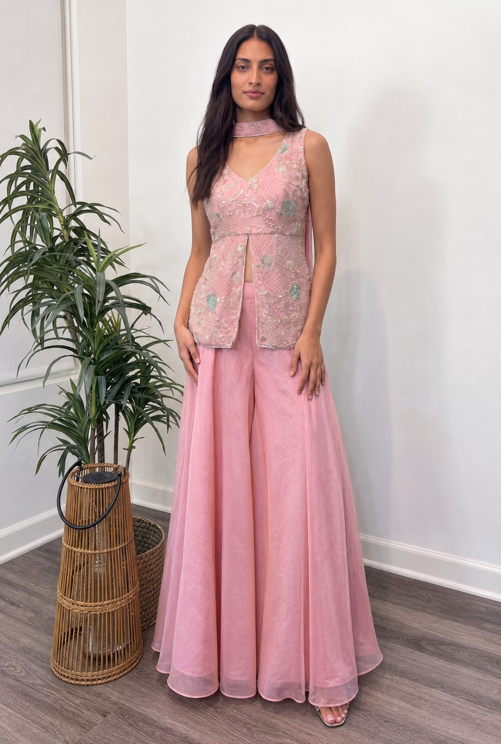 Model wearing the pink tissue sequin-embroidered top with matching flared pants, full view