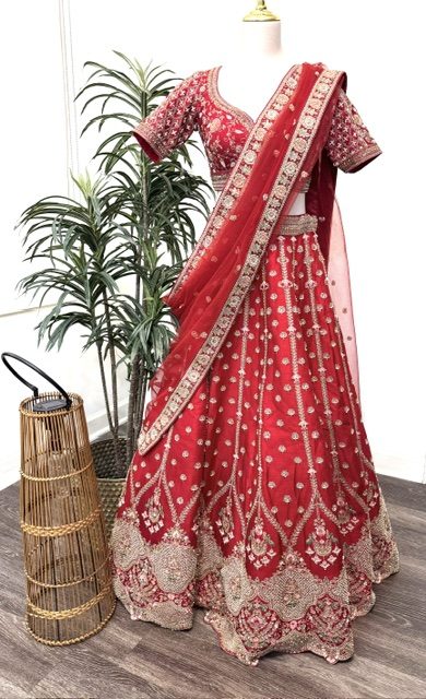 Red raw silk bridal lehenga with gold thread and pearl work and net dupatta, full view