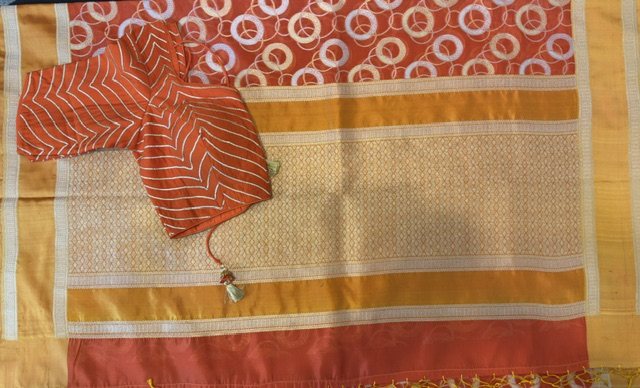 Rust orange saree with circle motif, border detail