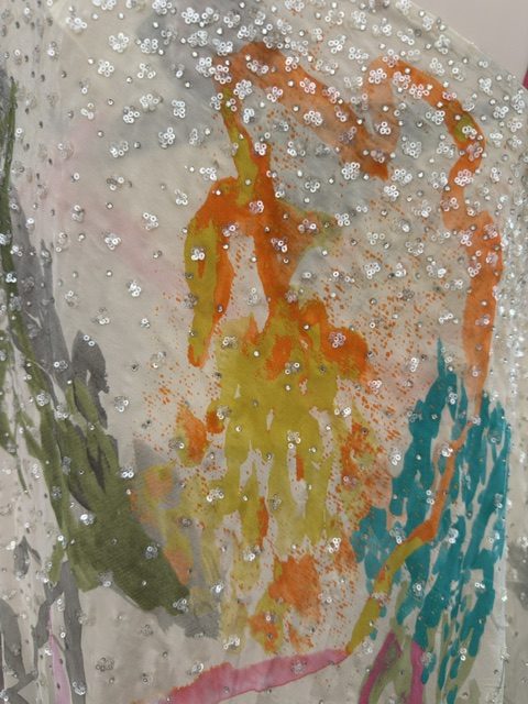 White printed top, close view of the painted floral print and silver sequin work